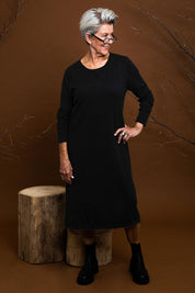 Model Elise wearing size S of The Everyday Knit Midi Dress in colour Black (Black), from the front, showing the whole outfit