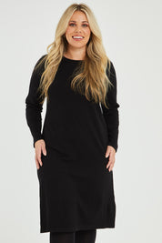 Model Katie wearing size XL of The Everyday Knit Midi Dress in colour Black (Black), from the front, cropped image