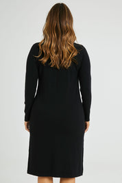 Model Laura wearing size L of The Everyday Knit Midi Dress in colour Black (Black), from the back