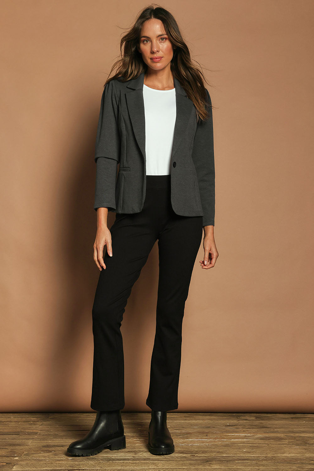 Model Madeline wearing size 10 of The Pull On Ponte Boot Leg Pant in colour Black (Black), from the front, showing the whole outfit