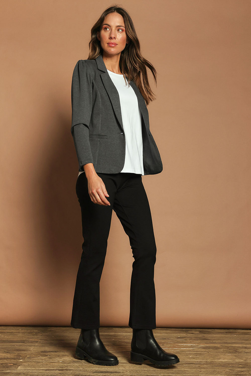 Model Madeline wearing size 10 of The Pull On Ponte Boot Leg Pant in colour Black (Black), from the front, showing the whole outfit