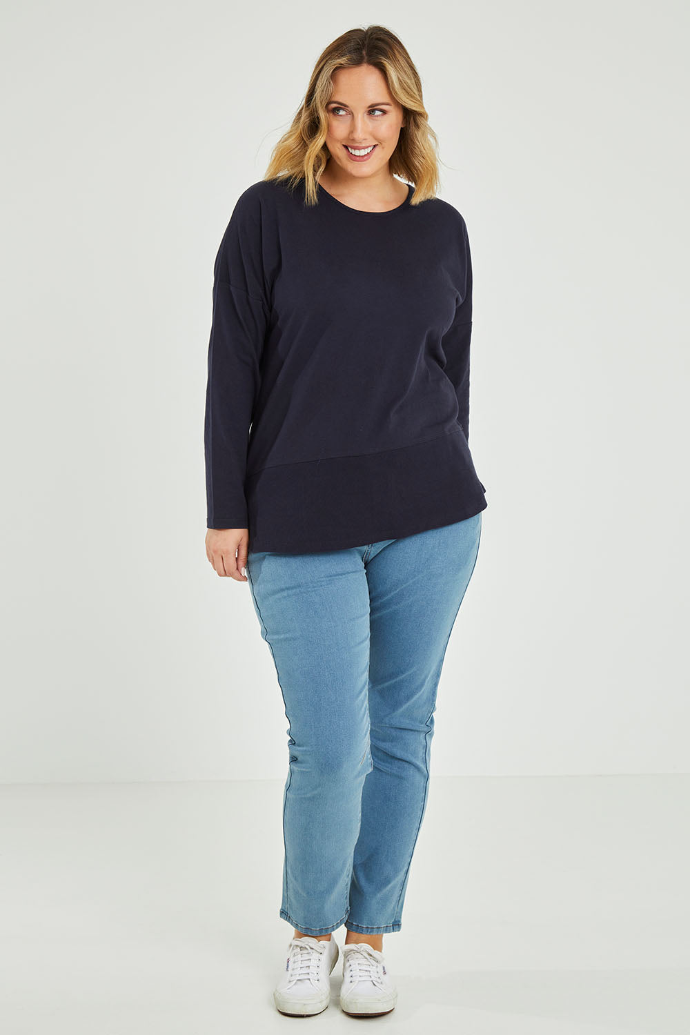 Model Jess wearing size 14 of The Rib Trim Long Sleeve Tee in colour Navy (Blue), from the front, showing the whole outfit