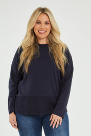 Model Katie wearing size 16 of The Rib Trim Long Sleeve Tee in colour Navy (Blue), from the front, cropped image