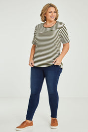 Model Fiona wearing size 16 of The Spliced Stripe Tee in colour Olive (Green), from the front, showing the whole outfit