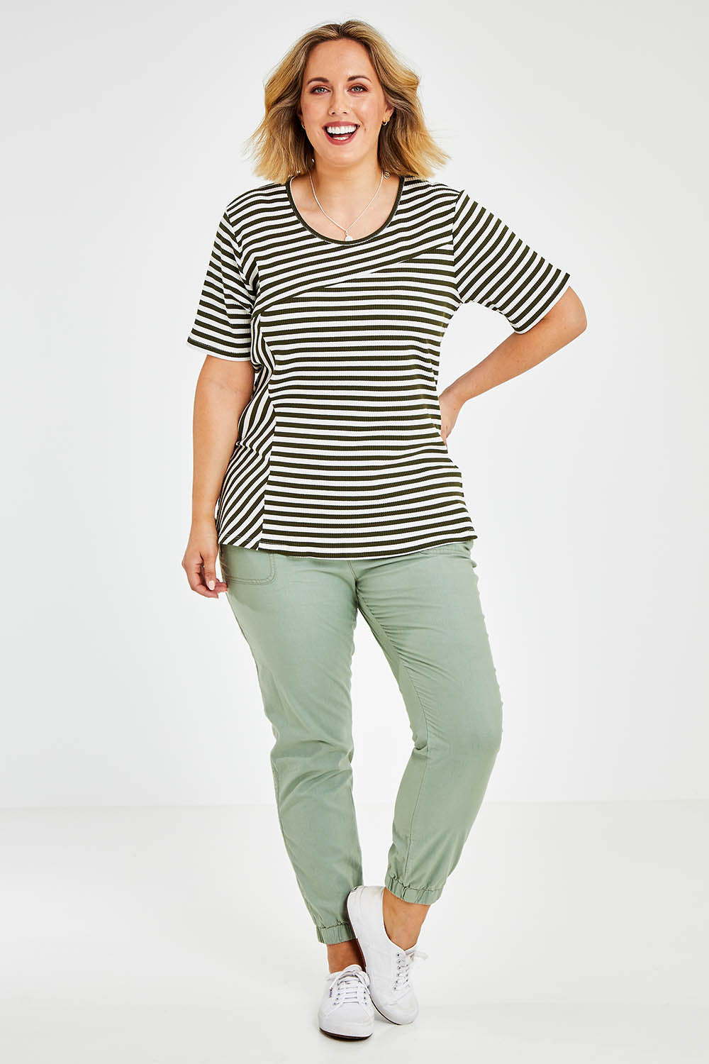 Model Jess wearing size 14 of The Spliced Stripe Tee in colour Olive (Green), from the front, showing the whole outfit
