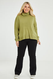 Model Katie wearing size XL of The Essential Soft High Low Jumper in colour Avocado (Green), from the front, showing the whole outfit