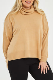 Model Katie wearing size XL of The Essential Soft High Low Jumper in colour Camel, from the front, cropped image