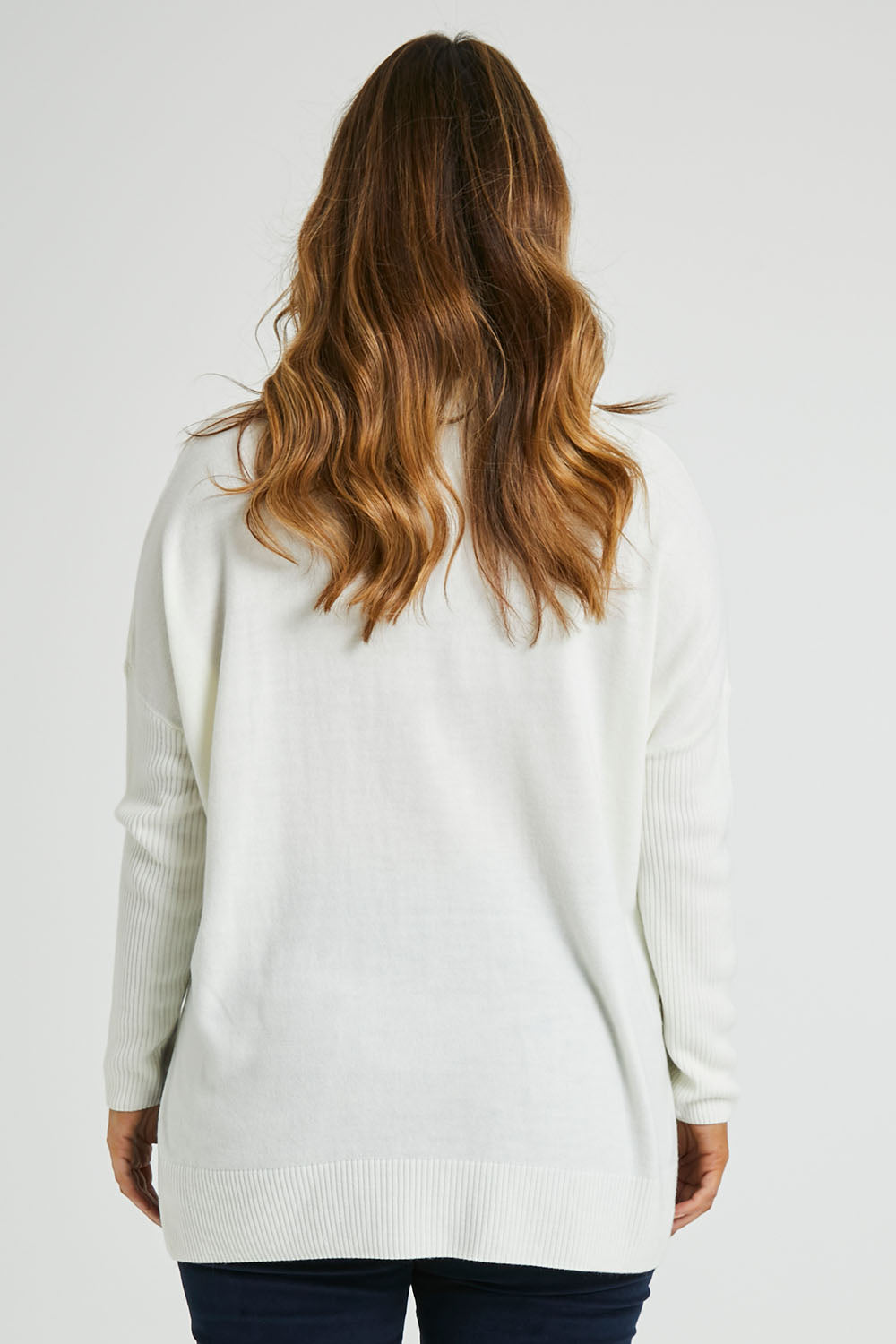 Model Laura wearing size L of The Essential Soft High Low Jumper in colour Snow (White), from the back