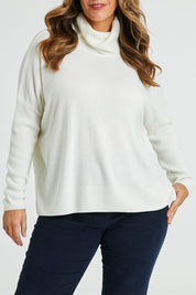 Model Laura wearing size L of The Essential Soft High Low Jumper in colour Snow (White), from the front, cropped image