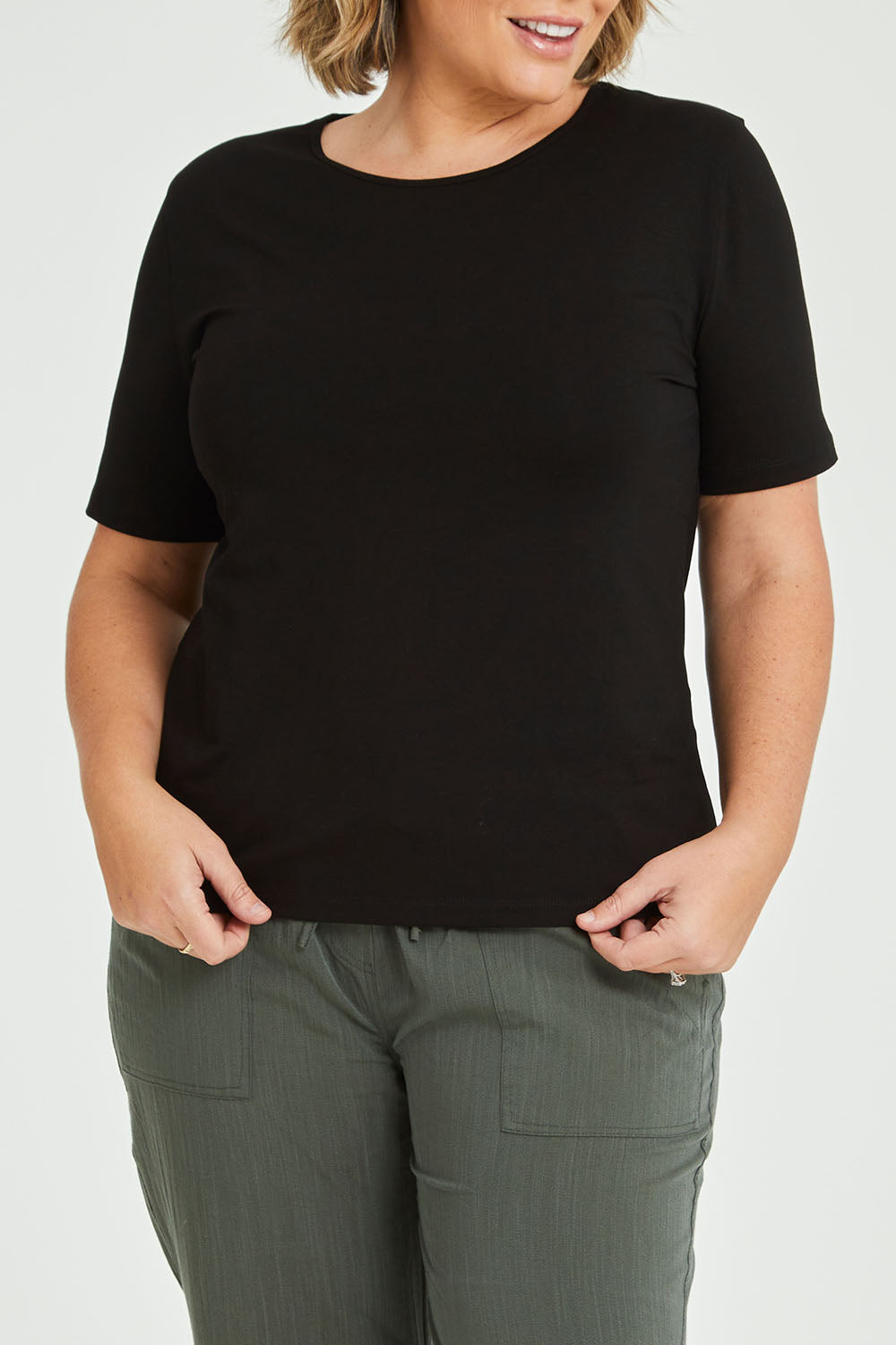 Model Fiona wearing size 16 of The Keepers Tee in colour Black (Black), from the front, cropped image