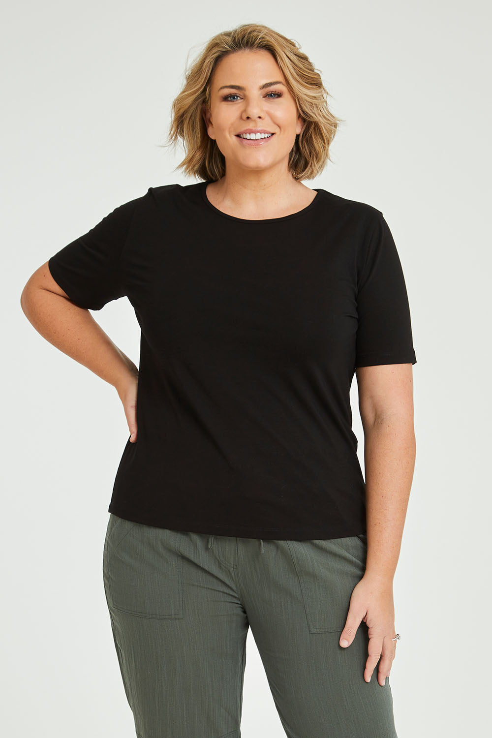 Model Fiona wearing size 16 of The Keepers Tee in colour Black (Black), from the front, cropped image