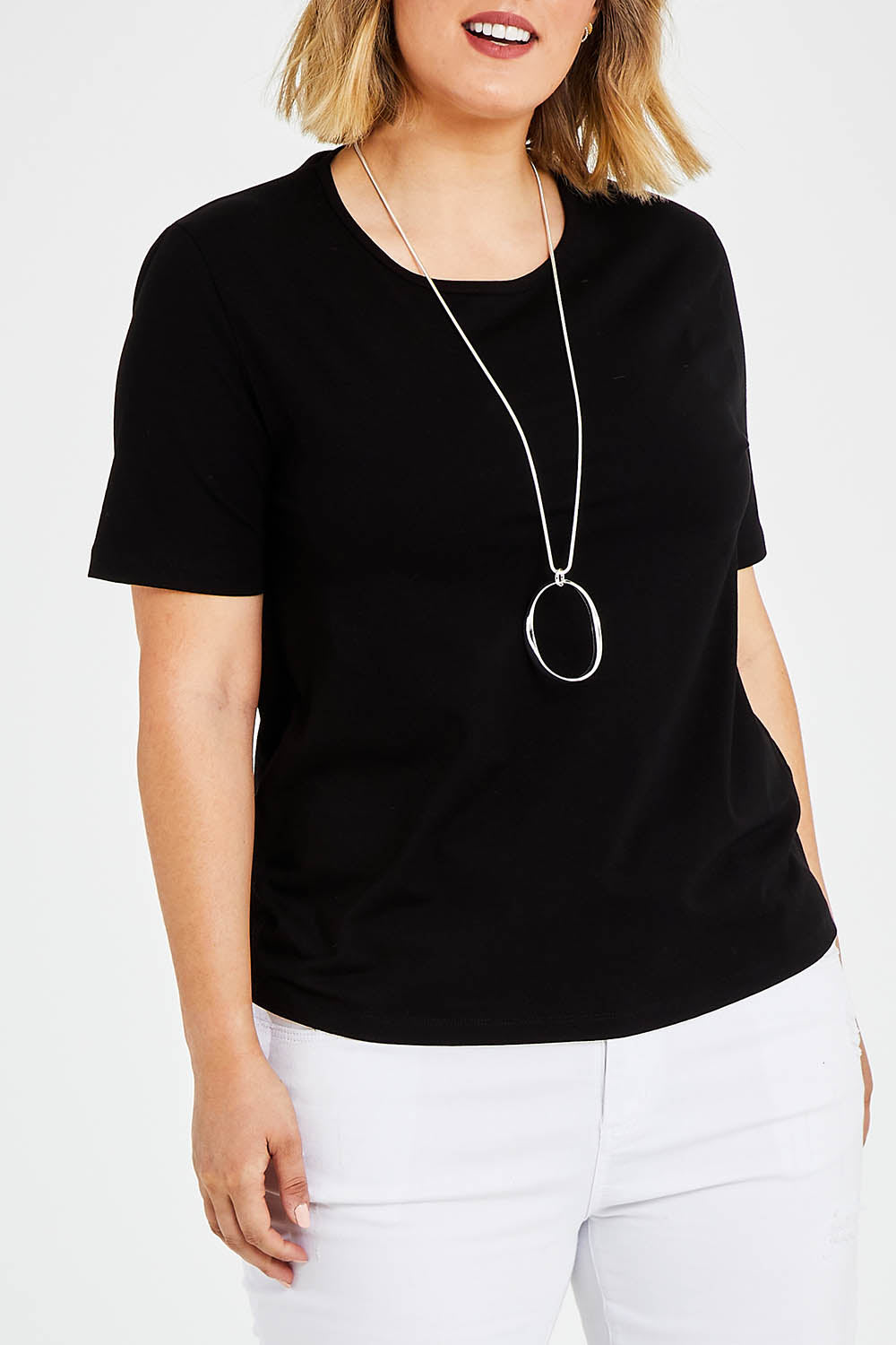 Model Jess wearing size 14 of The Keepers Tee in colour Black (Black), from the front, cropped image