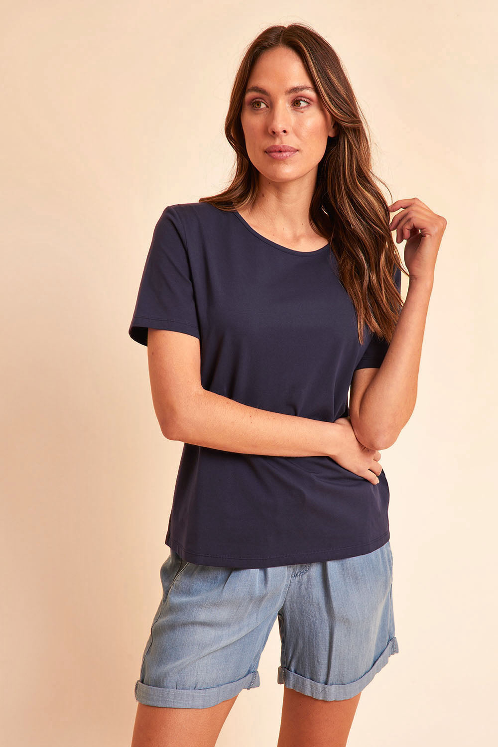 Model Madelinec wearing size 10 of the The Keepers Cotton Tee - Darknavy in colour Darknavy, from an angle