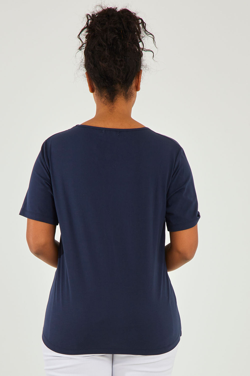 Model Noli wearing size 14 of The Keepers Tee in colour Darknavy (Blue), from the back
