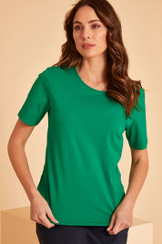 Model Madeline wearing size 10 of The Keepers Tee in colour Emerald (Green), from the front, showing the whole outfit