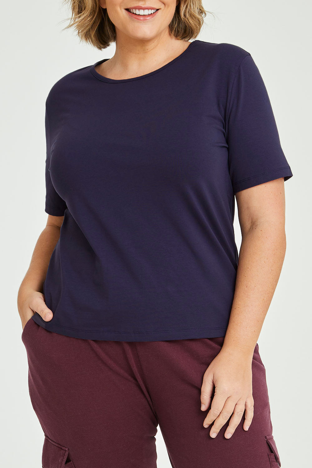 Model Fiona wearing size 16 of The Keepers Tee in colour Navy (Blue), from the front, cropped image