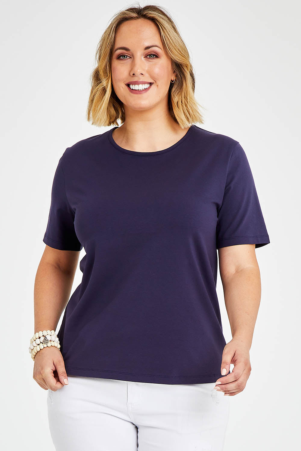 Model Jess wearing size 14 of The Keepers Tee in colour Navy (Blue), from the front, cropped image