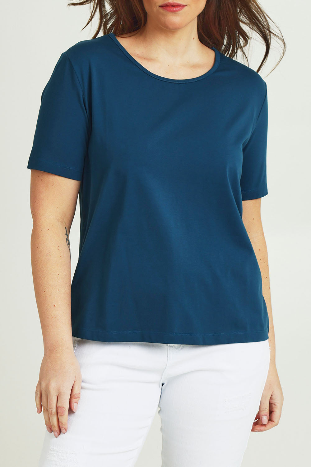 Model Jane wearing size 14 of The Keepers Tee in colour Opal (Blue), from the front, cropped image
