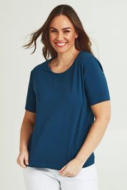 Model Jane wearing size 14 of The Keepers Tee in colour Opal (Blue), from the front, cropped image