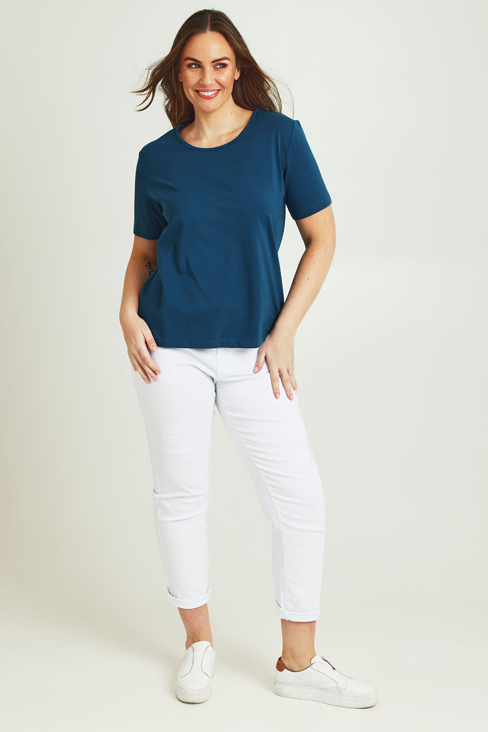 Model Jane wearing size 14 of The Keepers Tee in colour Opal (Blue), from the front, showing the whole outfit