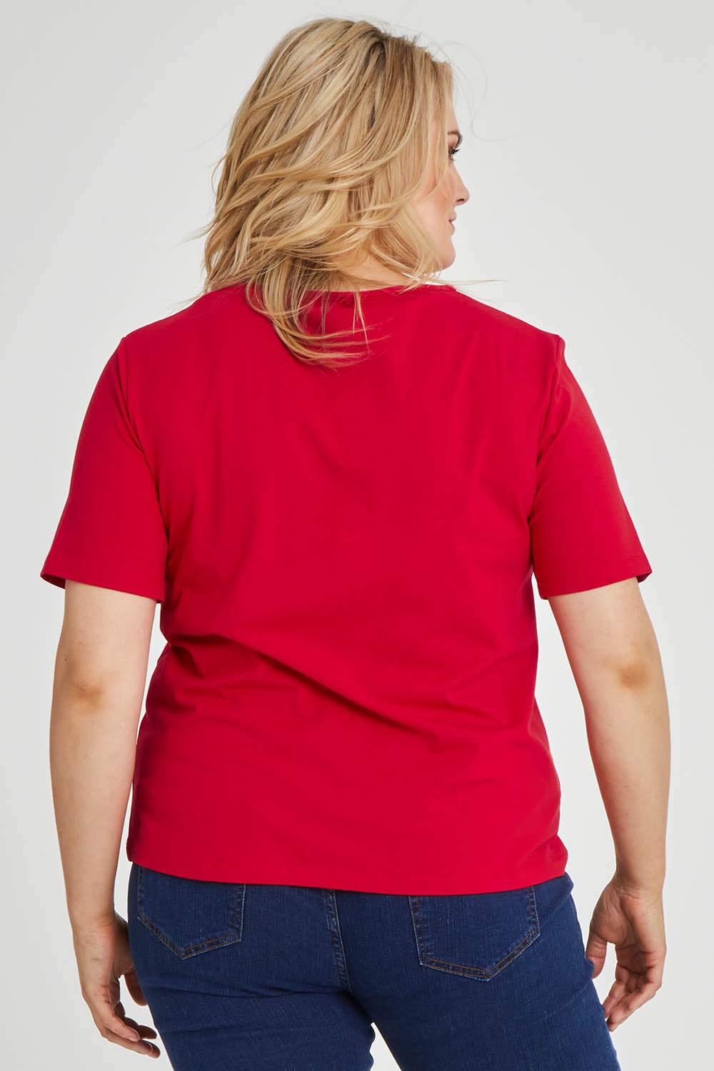 Model Keeara wearing size 16 of The Keepers Tee in colour Red (Red), from the back