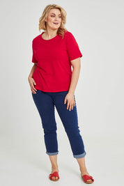 Model Keeara wearing size 16 of The Keepers Tee in colour Red (Red), from the front, showing the whole outfit