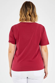 Model Jess wearing size 14 of The Keepers Tee in colour Rose (Pink), from the front, cropped image