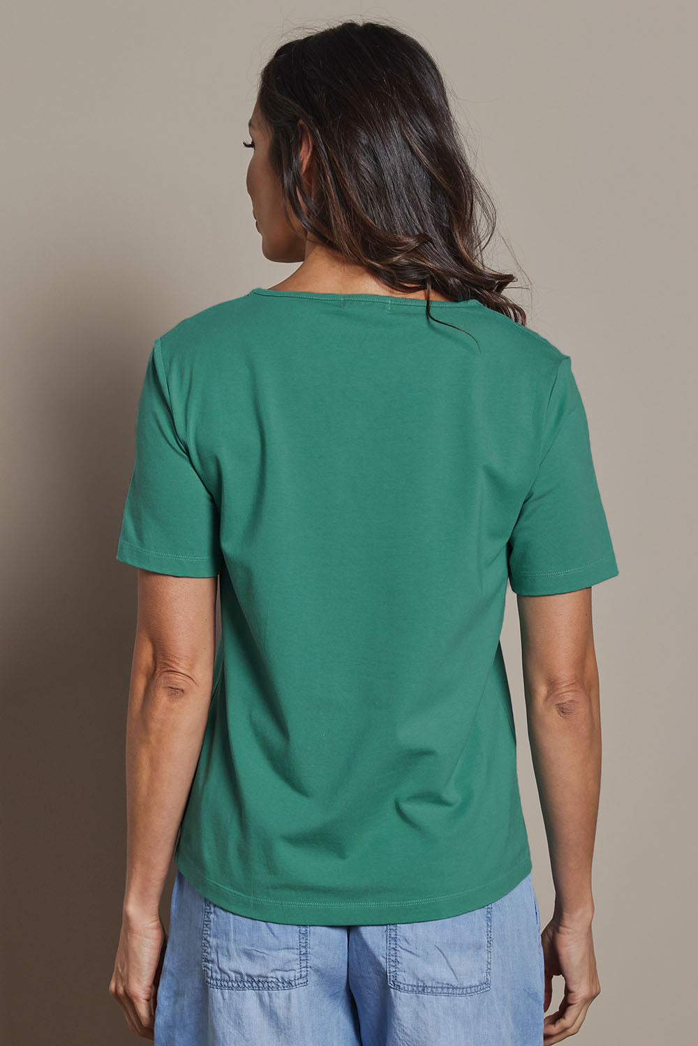Model Amanda wearing size 10 of The Keepers Tee in colour Seagreen (Green), from the back