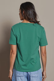 Model Amanda wearing size 10 of The Keepers Tee in colour Seagreen (Green), from the back