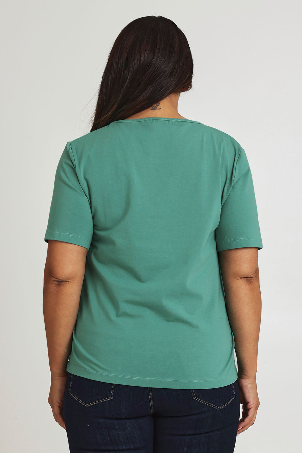 Model Ashleigh wearing size 16 of The Keepers Tee in colour Seagreen (Green), from the back
