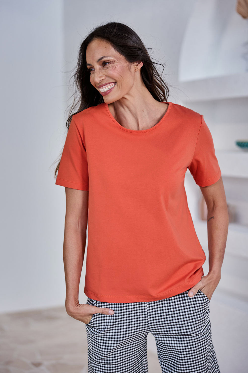 Model Amandam wearing size 10 of the The Keepers Cotton Tee – Sunset in colour Sunset, in a cropped view