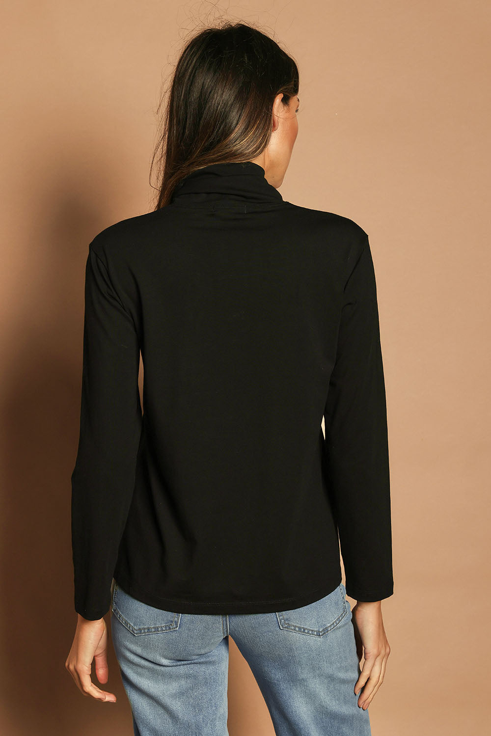 Model Madeline wearing size 10 of The Keepers Skivvy in colour Black (Black), from the back
