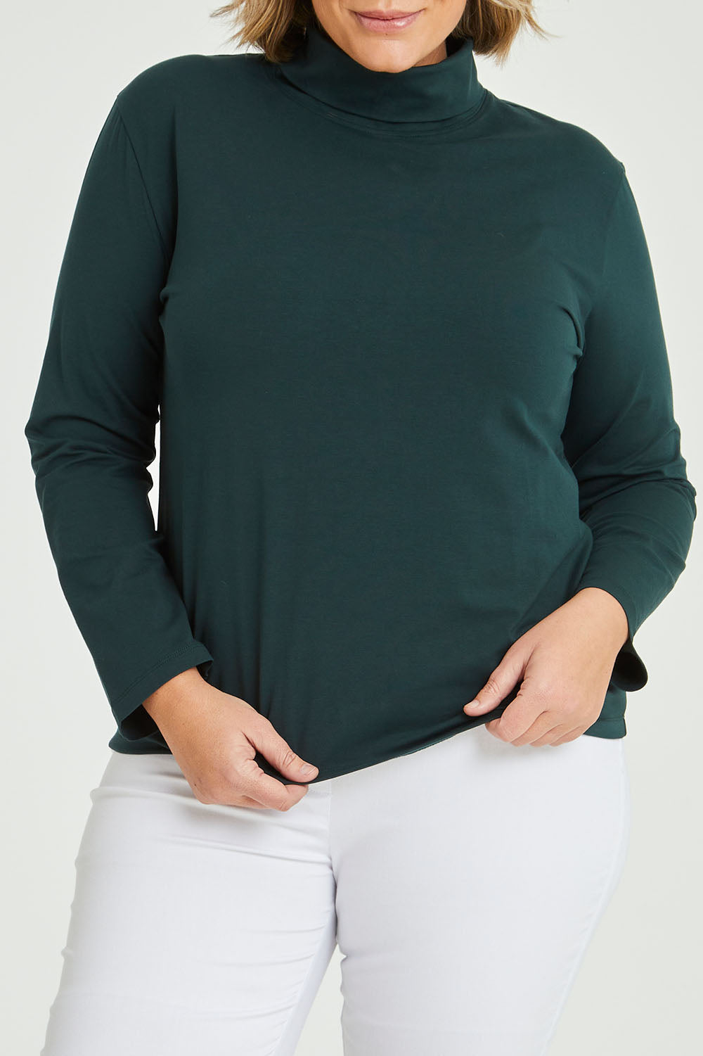 Model Fiona wearing size 16 of The Keepers Skivvy in colour Pinegreen (Green), from the front, cropped image