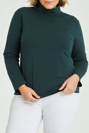 Model Fiona wearing size 16 of The Keepers Skivvy in colour Pinegreen (Green), from the front, cropped image