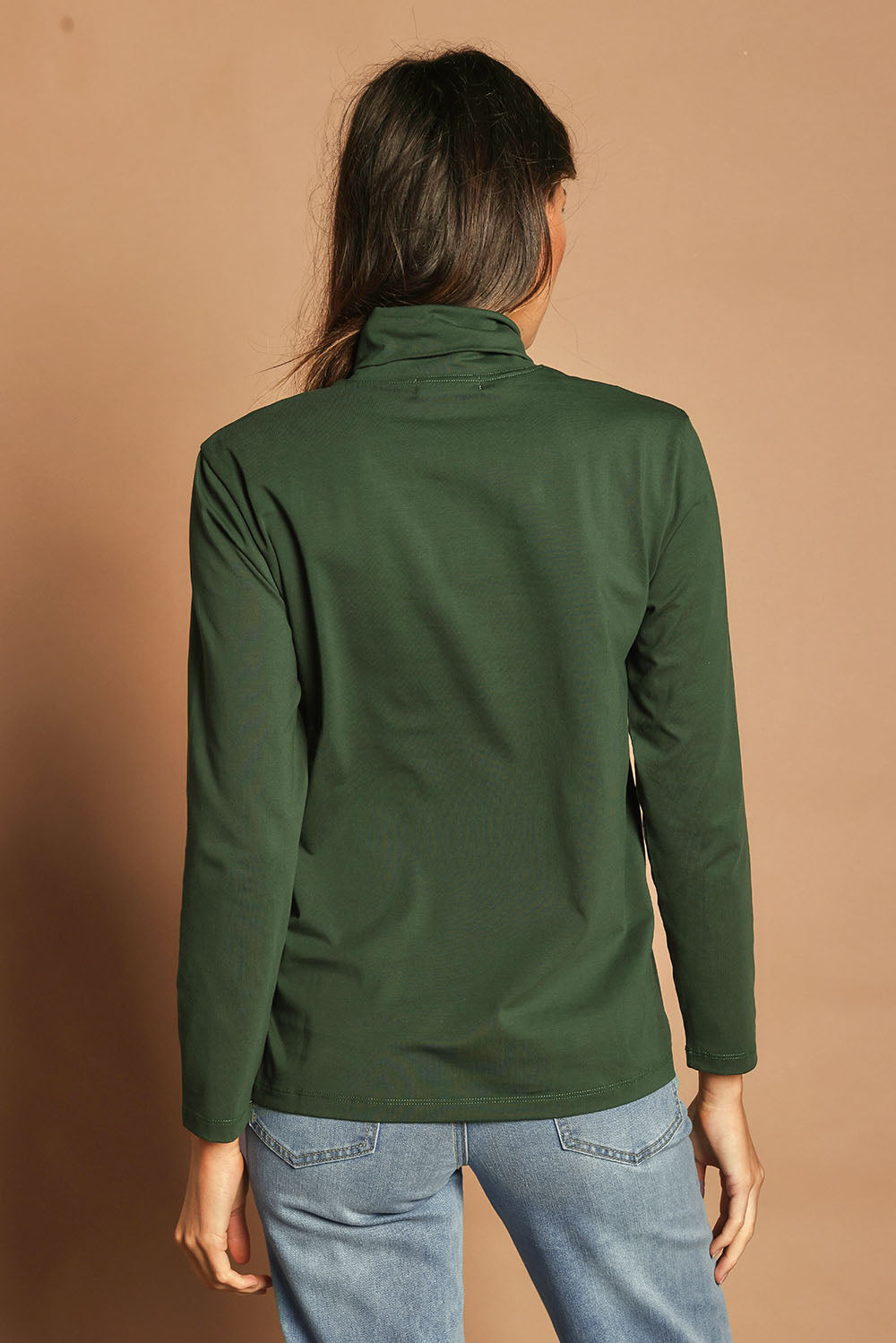 Model Madeline wearing size 10 of The Keepers Skivvy in colour Pinegreen (Green), from the back