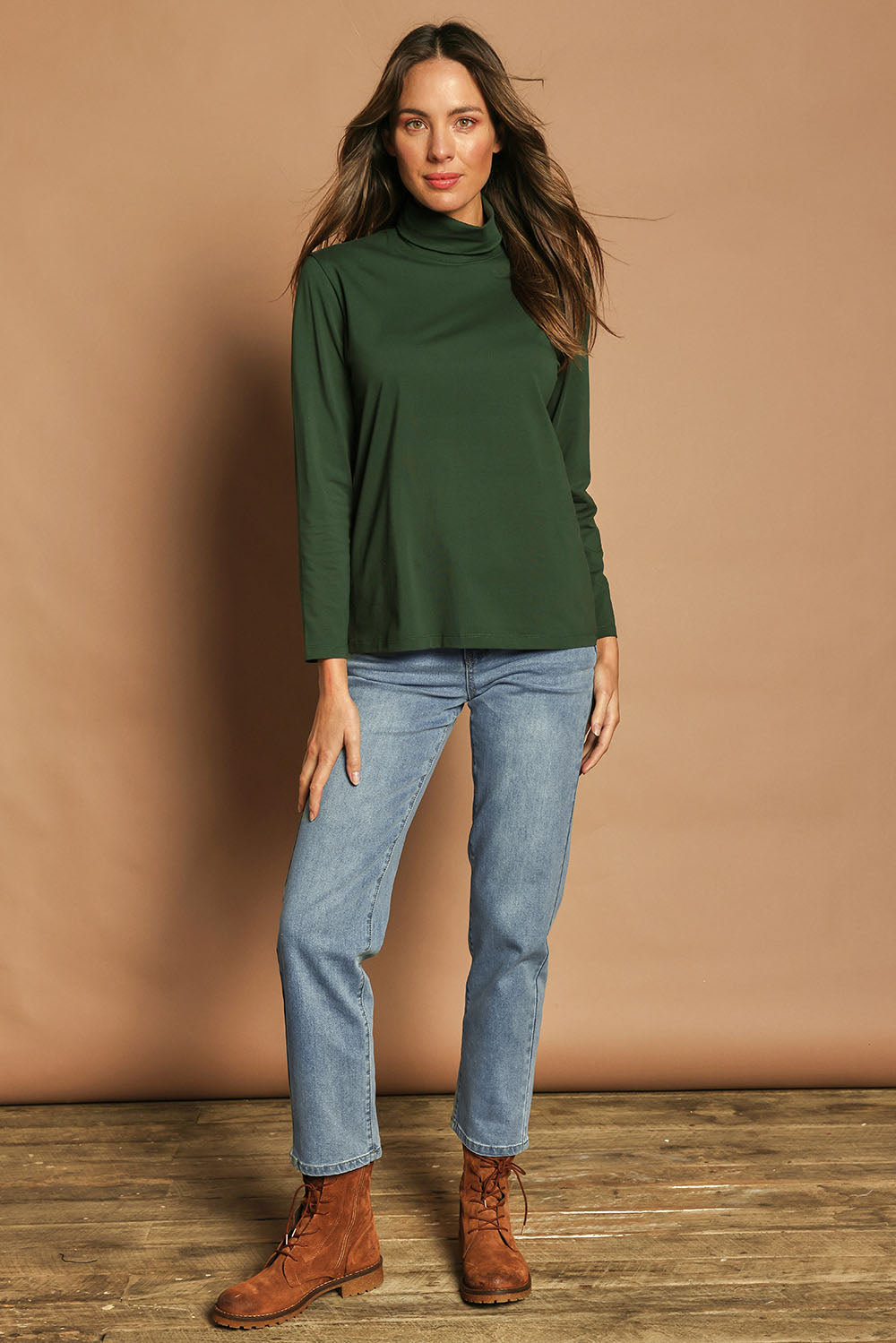 Model Madeline wearing size 10 of The Keepers Skivvy in colour Pinegreen (Green), from the front, showing the whole outfit