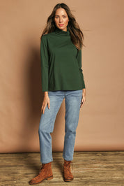 Model Madeline wearing size 10 of The Keepers Skivvy in colour Pinegreen (Green), from the front, showing the whole outfit