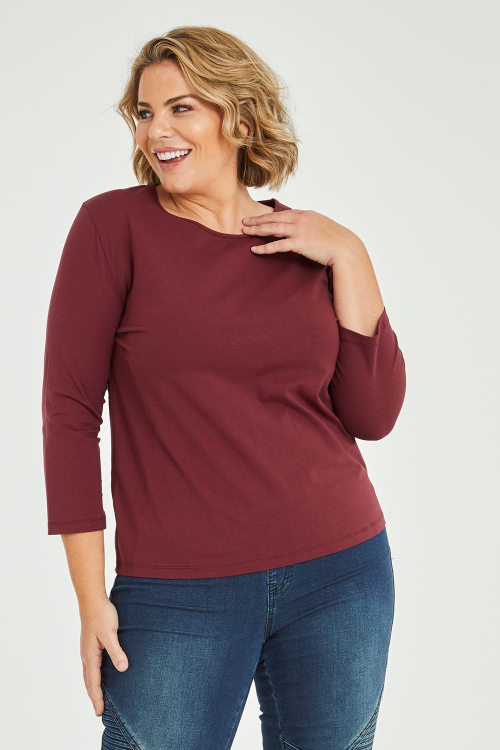 Model Fiona wearing size 16 of The Keepers 3/4 Sleeve Tee in colour Burgundy (Purple), from the front, cropped image