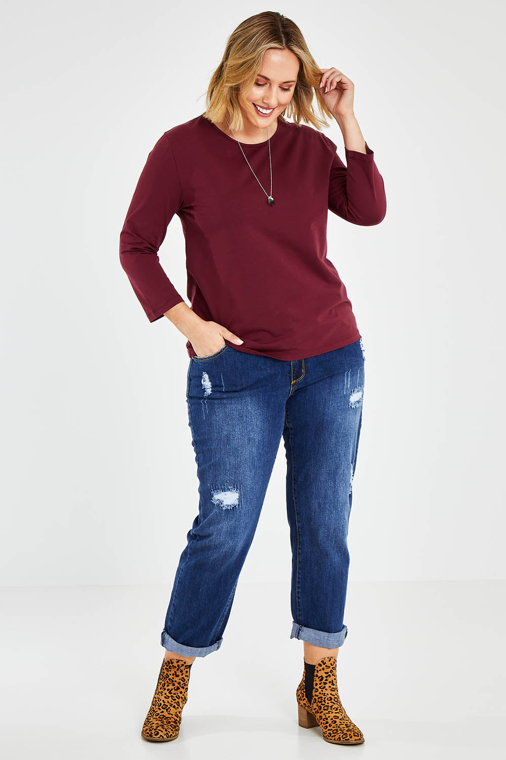 Model Jess wearing size 14 of The Keepers 3/4 Sleeve Tee in colour Burgundy (Purple), from the front, showing the whole outfit