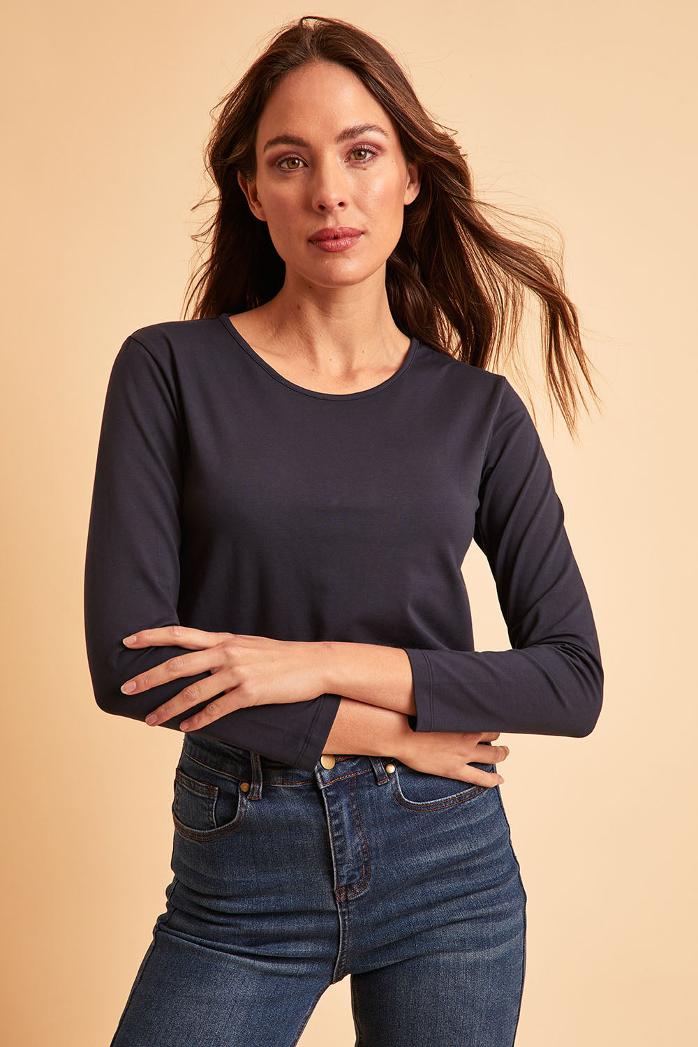 Model Madeline wearing size 10 of The Keepers Long Sleeve Tee in colour Darknavy (Blue), from the front, showing the whole outfit