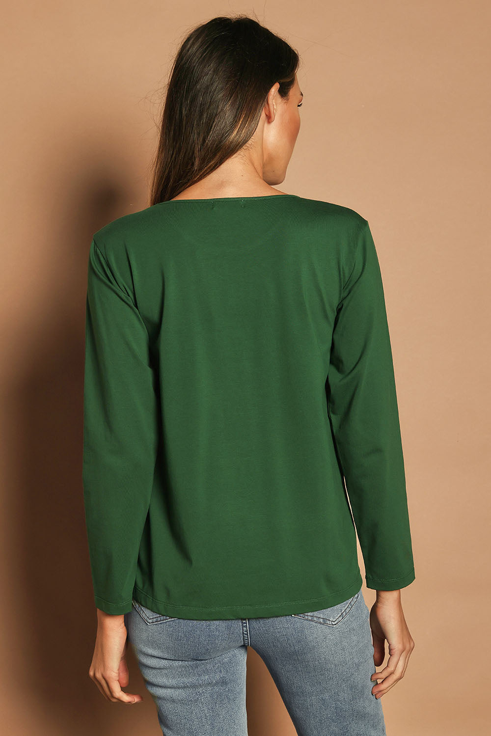 Model Madeline wearing size 10 of The Keepers Long Sleeve Tee in colour Forest (Green), from the back