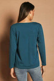 Model Madeline wearing size 10 of The Keepers Long Sleeve Tee in colour Opal (Blue), from the back