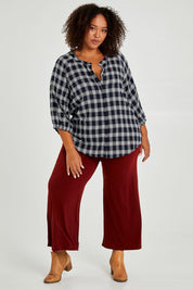 Model Alexis wearing size 16 of The Recycled Wide Leg Pant in colour Terracotta, from the front, showing the whole outfit