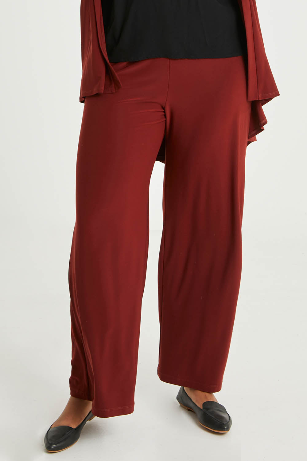 Model Noli wearing size 14 of The Recycled Wide Leg Pant in colour Terracotta, from the front, cropped image