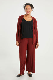 Model Noli wearing size 14 of The Recycled Wide Leg Pant in colour Terracotta, from the front, showing the whole outfit