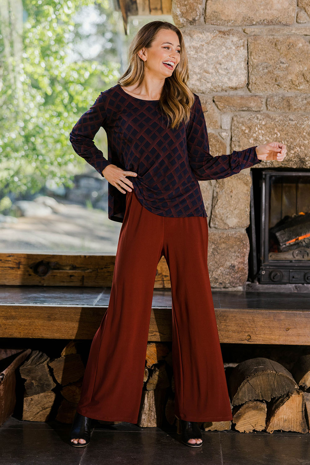 Model Tahlia wearing size 10 of The Recycled Wide Leg Pant in colour Terracotta, from the front, showing the whole outfit