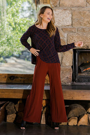 Model Tahlia wearing size 10 of The Recycled Wide Leg Pant in colour Terracotta, from the front, showing the whole outfit