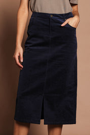 Model Madeline wearing size 10 of The 5 Pocket Cord Midi Skirt in colour Darknavy (Blue), from the front, cropped image