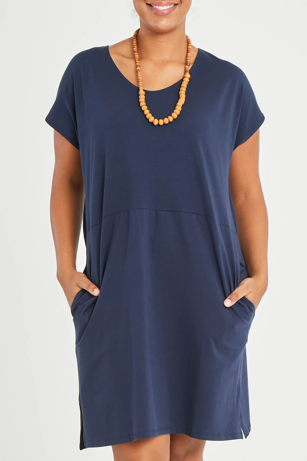 Model Noli wearing size 14 of The Luxe Cotton Tee Dress in colour Navy (Blue), from the front, cropped image
