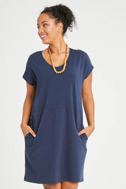 Model Noli wearing size 14 of The Luxe Cotton Tee Dress in colour Navy (Blue), from the front, cropped image